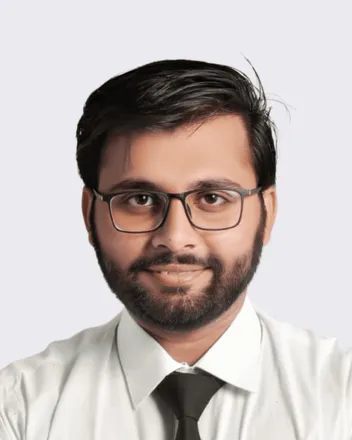 Portrait of Ashar Khalid in a white shirt and dark tie, arms folded.